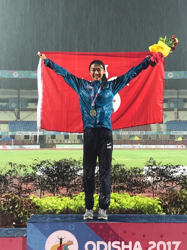 Cecilia Yeung Man-wai celebrates her silver medal as the rain pours down at the Asian Championships in India. Photo: Facebook / Hong Kong Amateur Athletic Association