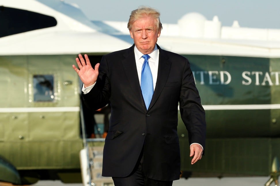 US President Donald Trump waves before his departs from Newark Liberty International airport after a weekend at Trump National Golf Club. Photo: Reuters