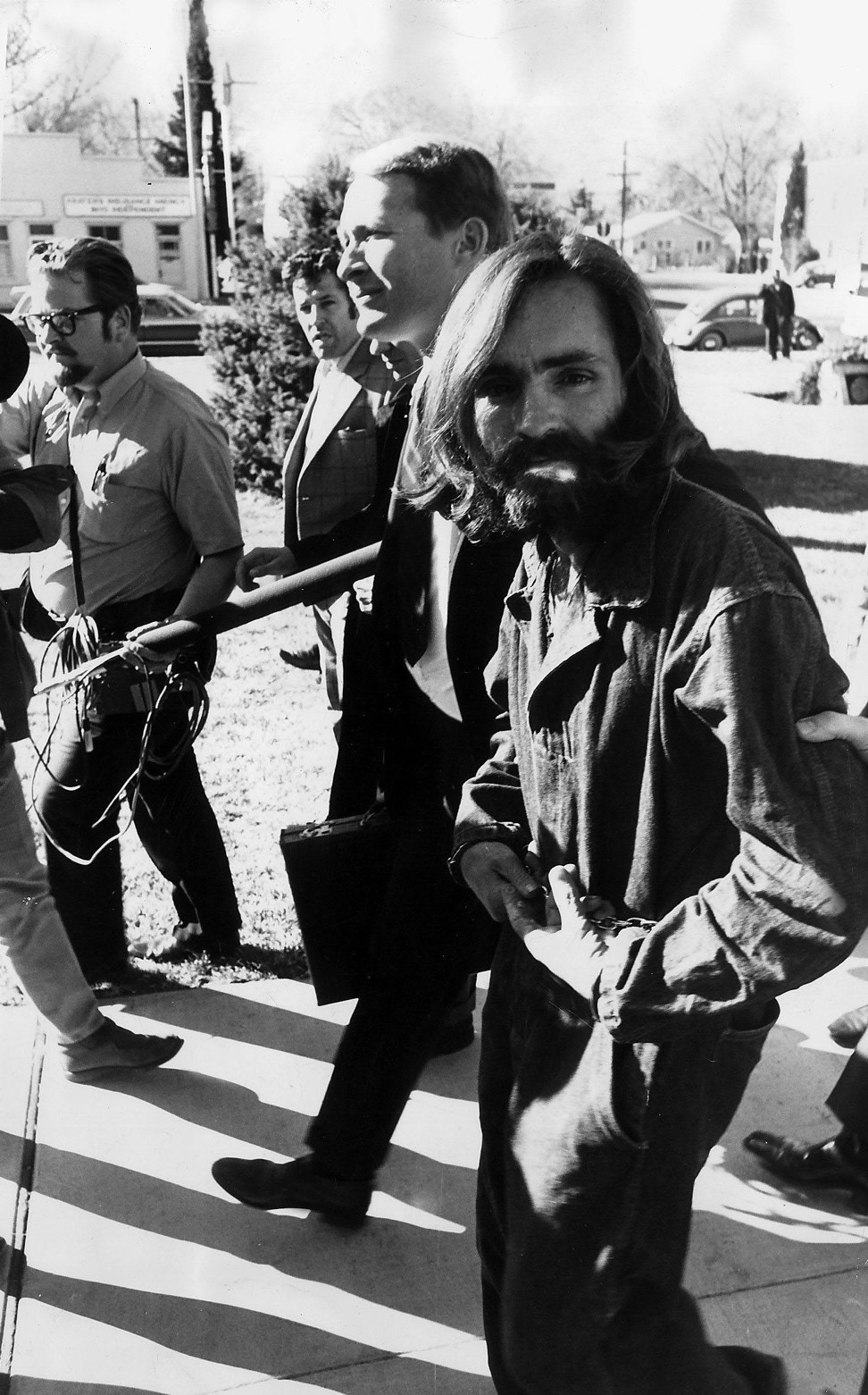 Charles Manson being led away by police agents after being accused of the murders of Sharon Tate and four others. Photo: Alamy