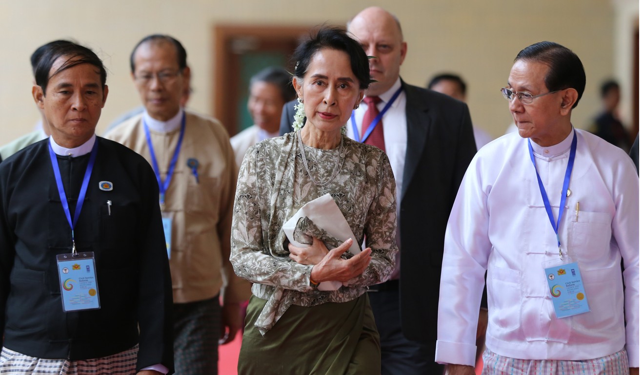 Myanmar's State Counsellor Aung San Suu Kyi, centre, leaves after a ceremony for the launch of the Civil Service Reform Strategic Action Plan For Myanmar in Naypyitaw. Photo: EPA