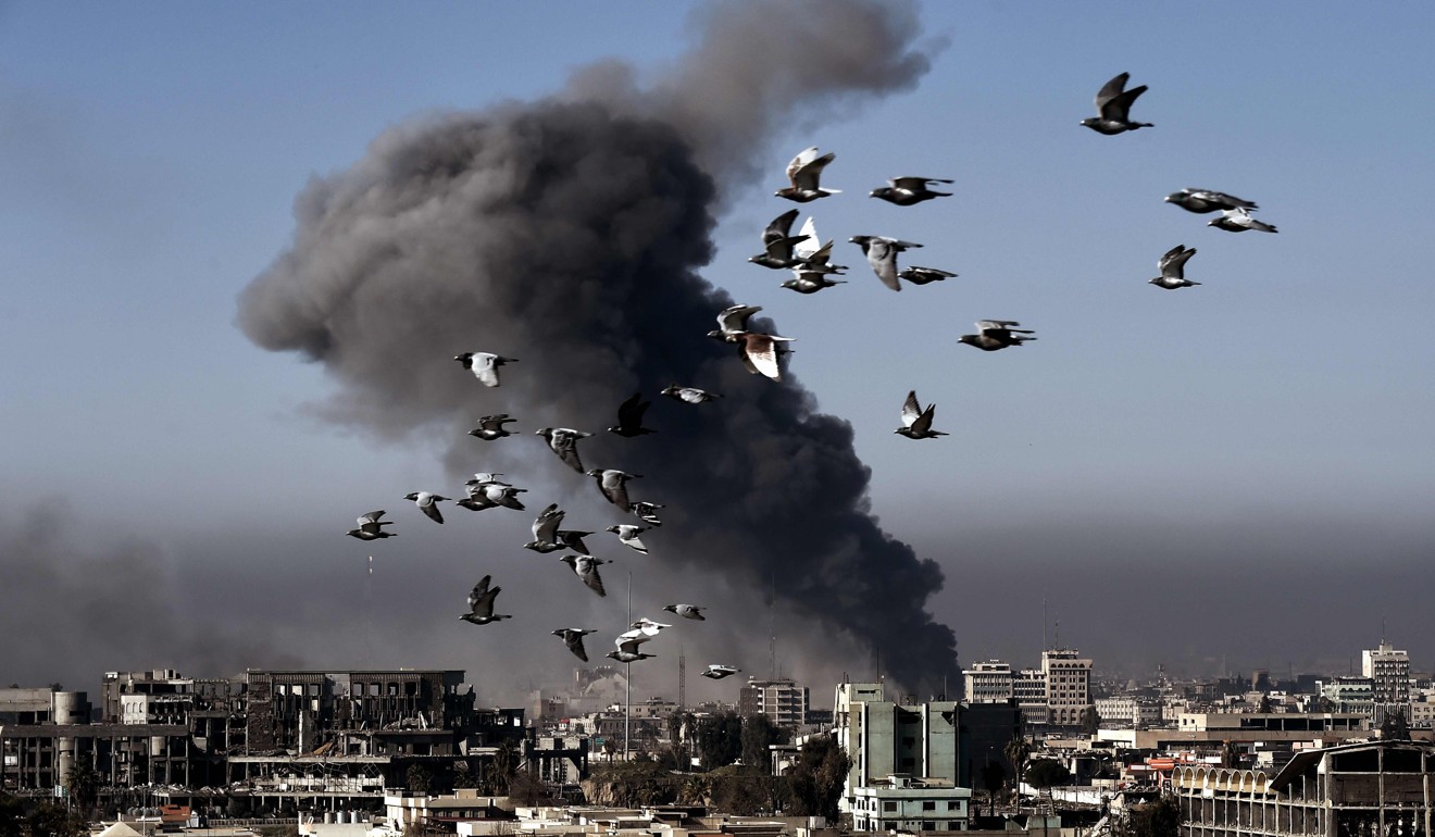 Smoke rises following an air strike on an IS-held part of Mosul, Iraq, in March. Photo: AFP