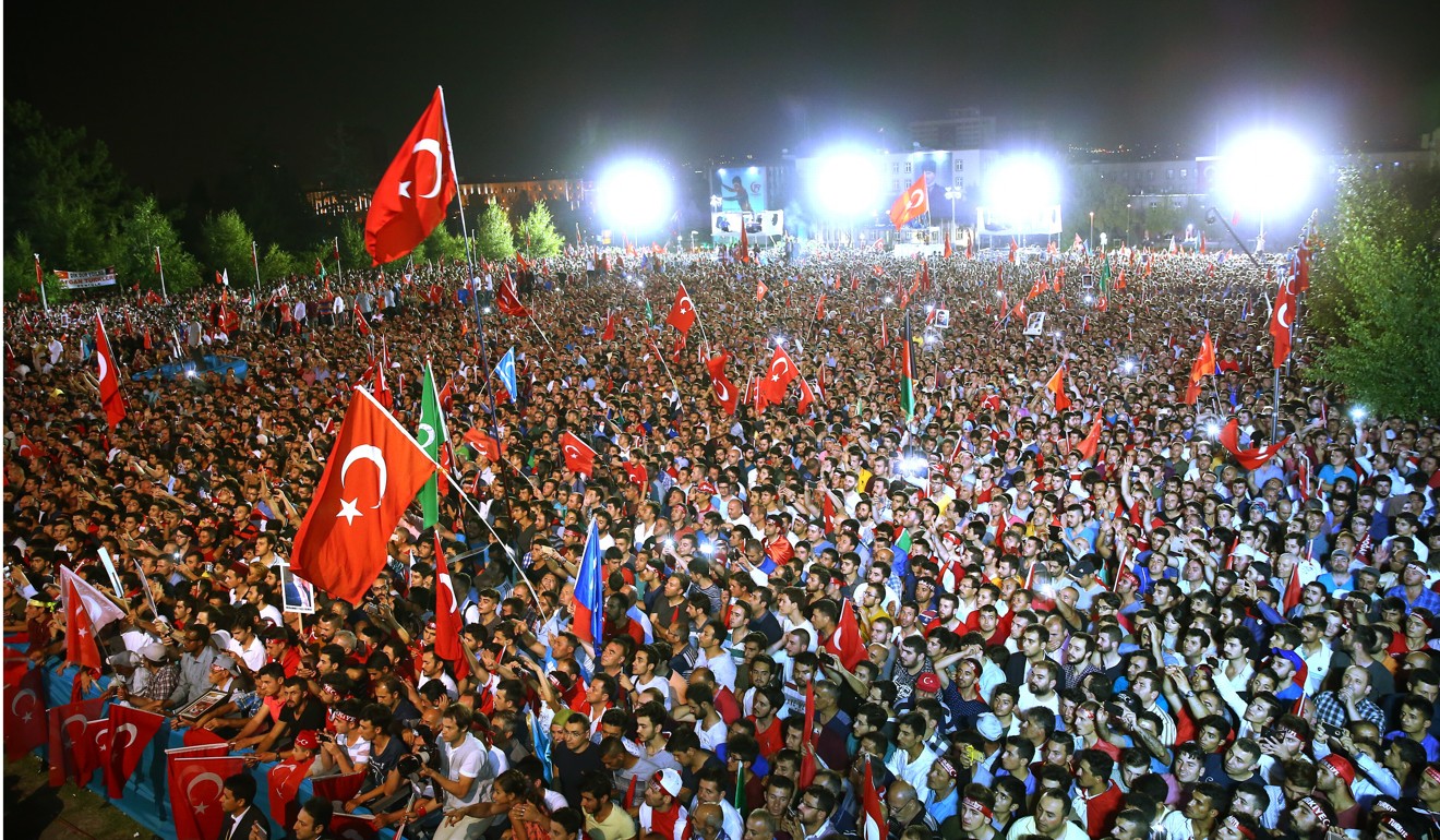 People outside Turkey's parliament to commemorate the failed coup anniversary. Photo: AP