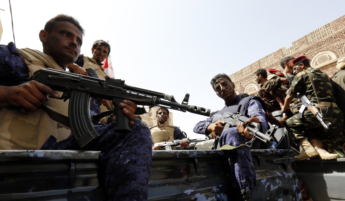 Newly recruited Houthi fighters ride vehicles during a gathering to mobilise more fighters to fight Saudi-backed Yemeni forces. Photo: EPA