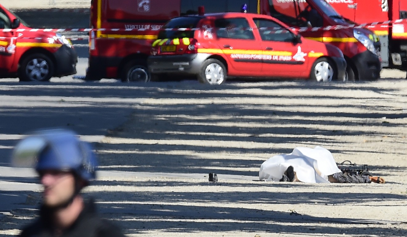 A body lyes down on the Champs Elysees avenue after a man rammed into a police convoy in Paris, on Monday, June 19, 2017. France's interior minister says the attempted attack on security forces shows the threat is still very high in the country and justifies the state of emergency. Photo: AP