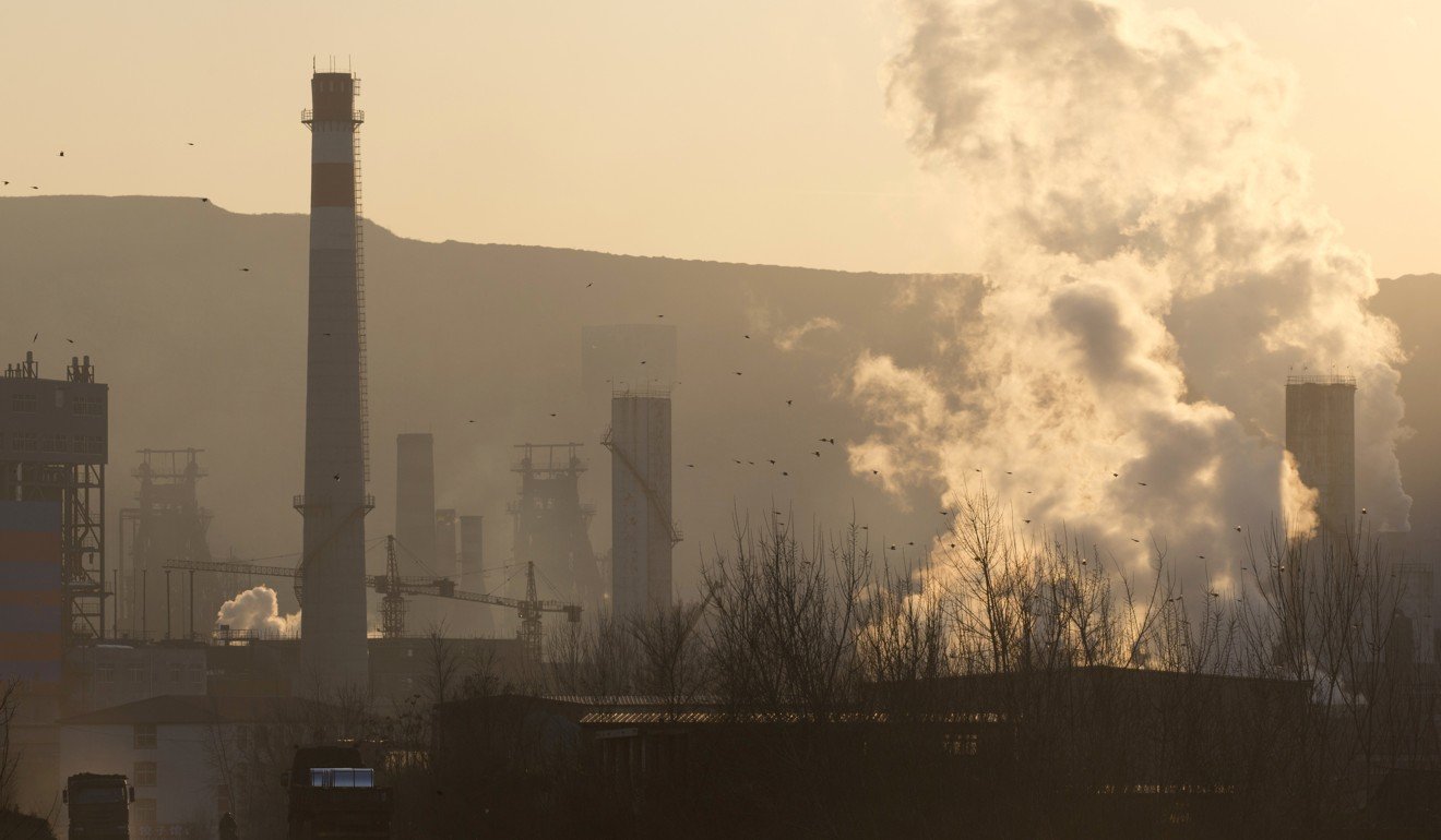 A man walks near the Shougang steel mills in Qianan in northern China's Hebei province. Photo: Associated Press