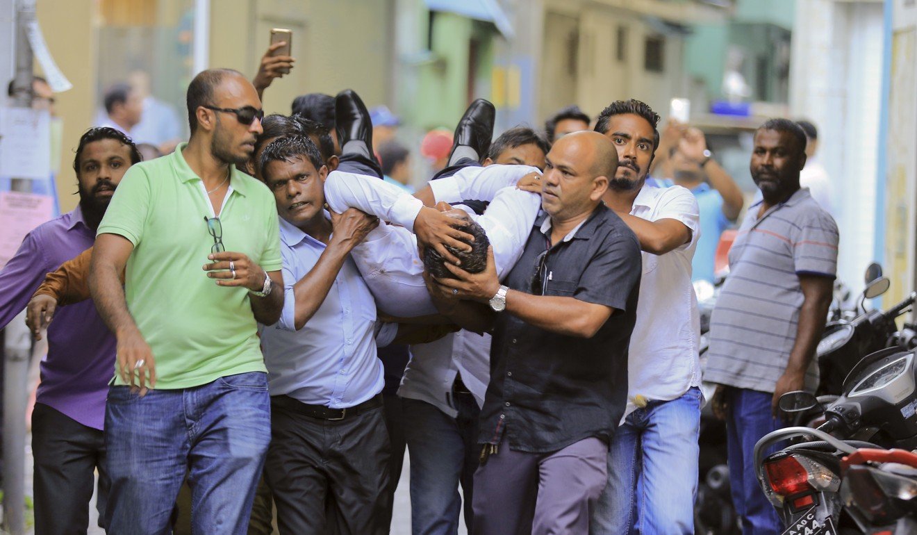 Maldivian lawmaker Faisal Naseem was injured in clashes with police and then rushed to a hospital. Photo: AP