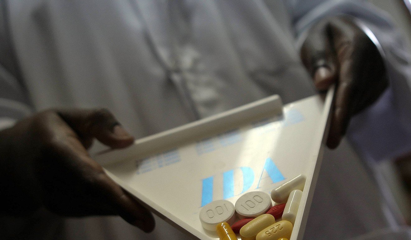 A pharmacist carries retroviral drugs at a clinic in Uganda, where more than a million people have been diagnosed as carrying the HIV virus: Photo: AFP