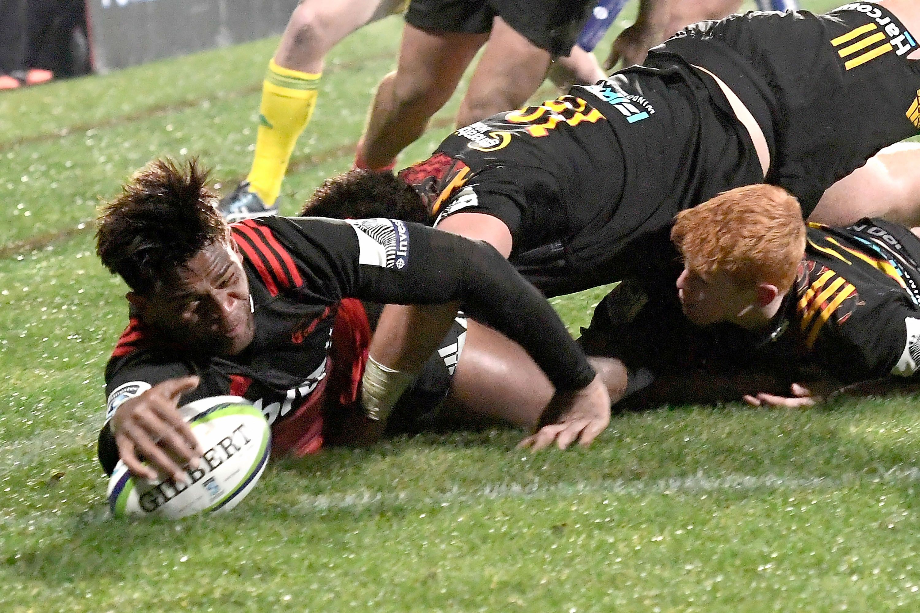 Canterbury Crusaders' Seta Tamanivalu (left) scores a try against the Waikato Chiefs. Photo: AFP