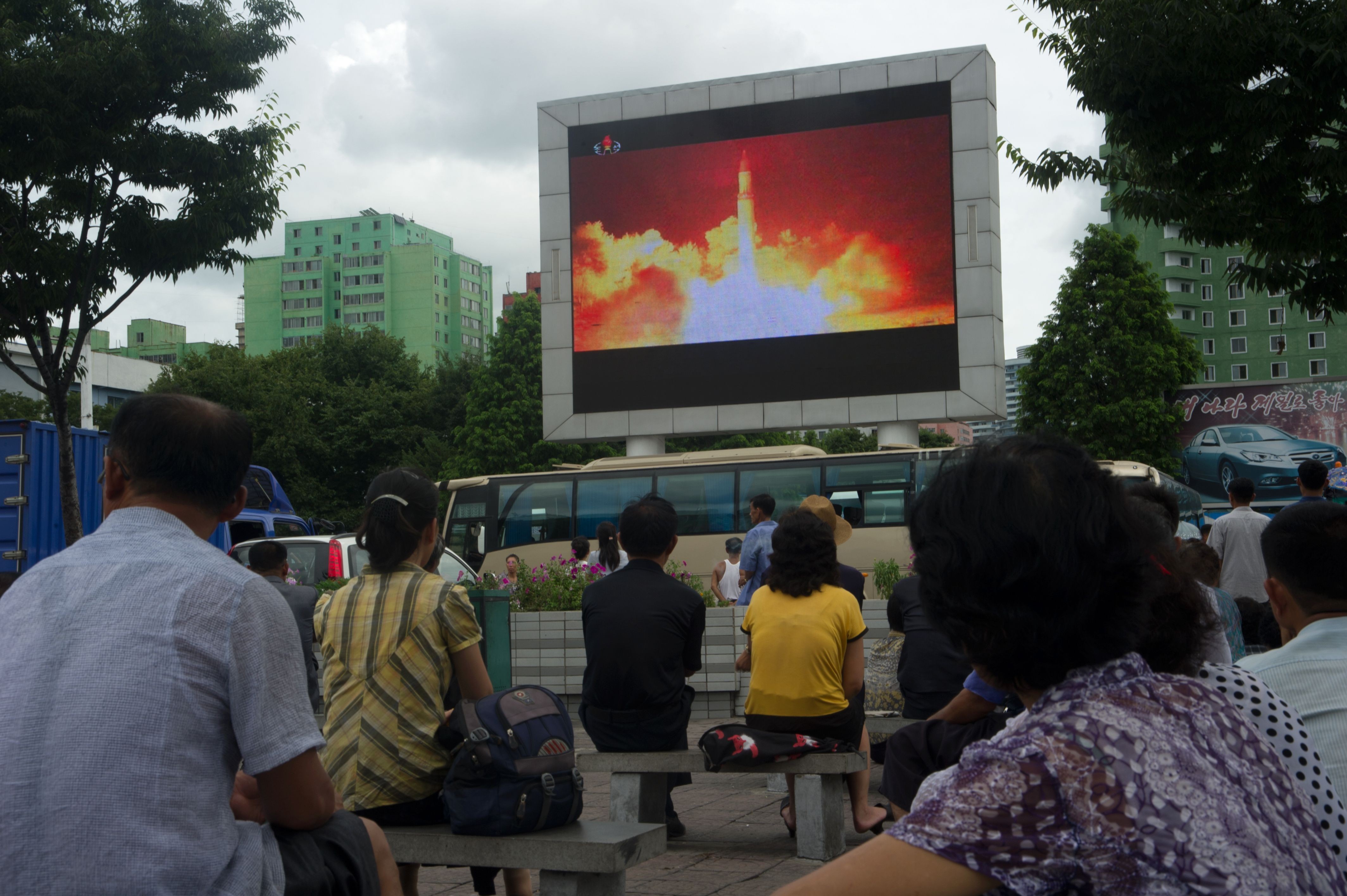 People watch as coverage of a North Korean intercontinental ballistic missile test is displayed on a screen in a public square in Pyongyang, on July 29. Photo: AFP