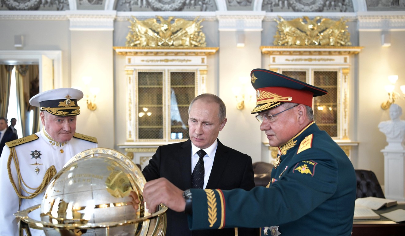 Russian President Vladimir Putin (C), Defence Minister Sergei Shoigu (R) and Commander-in-Chief of the Russian Navy Vladimir Korolev visit the Admiralty historical building on the Navy Day in St Petersburg. Putin has vowed to retaliate against the US over its sanctions bill. Photo: Reuters