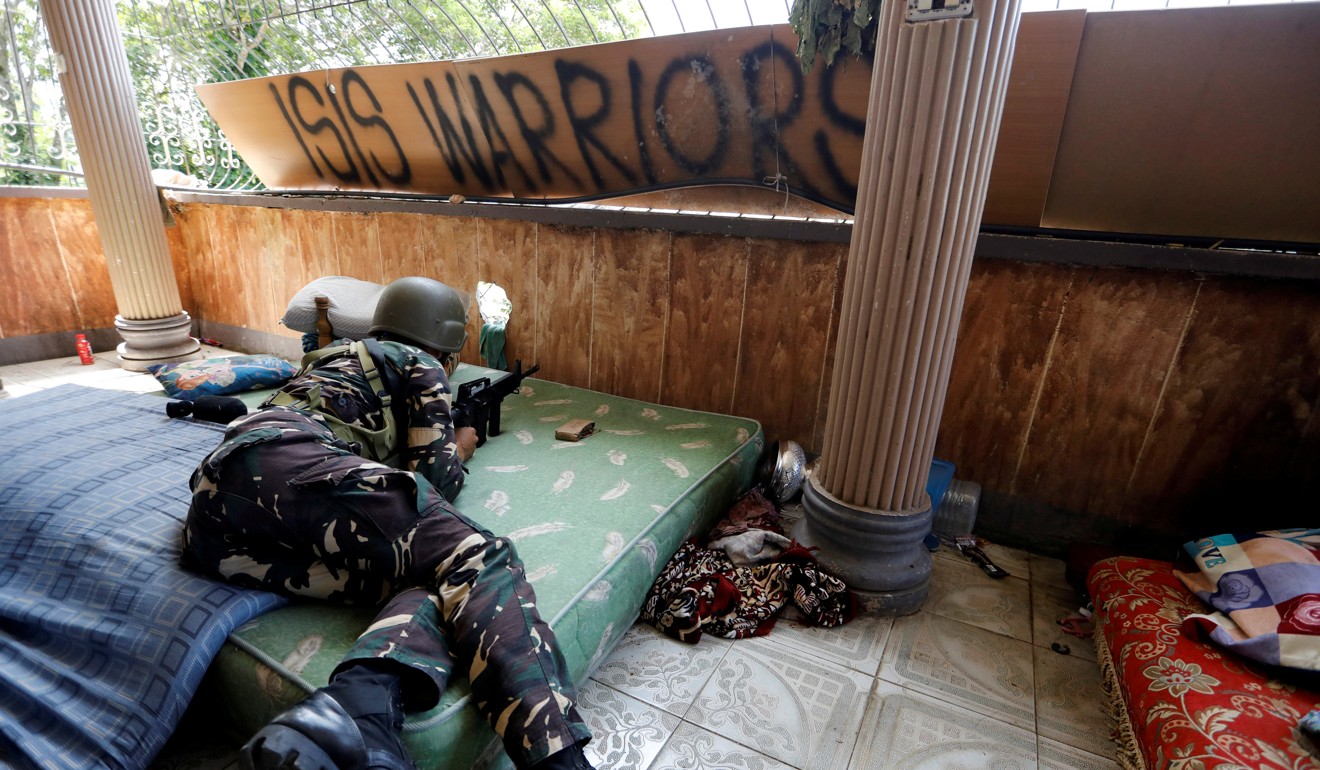 A soldier takes cover in Marawi city, Philippines. File photo: Reuters