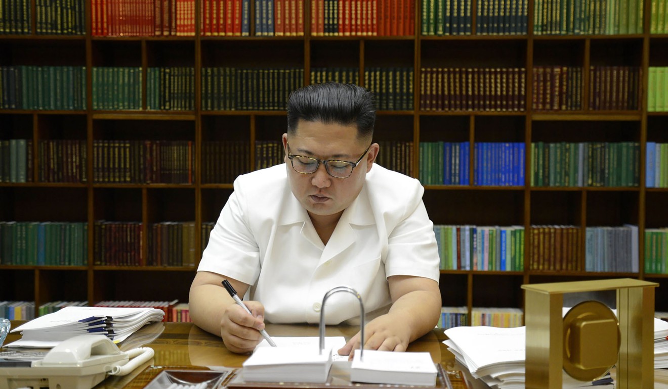 This July 27, 2017 picture released from North Korea's official Korean Central News Agency (KCNA) shows North Korean leader Kim Jong-un signing documents for test launch of an intercontinental ballistic missile. Photo: AFP
