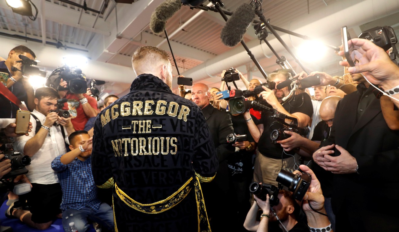 Conor McGregor wears a new custom-made robe as he talks with reporters. Photo: Reuters