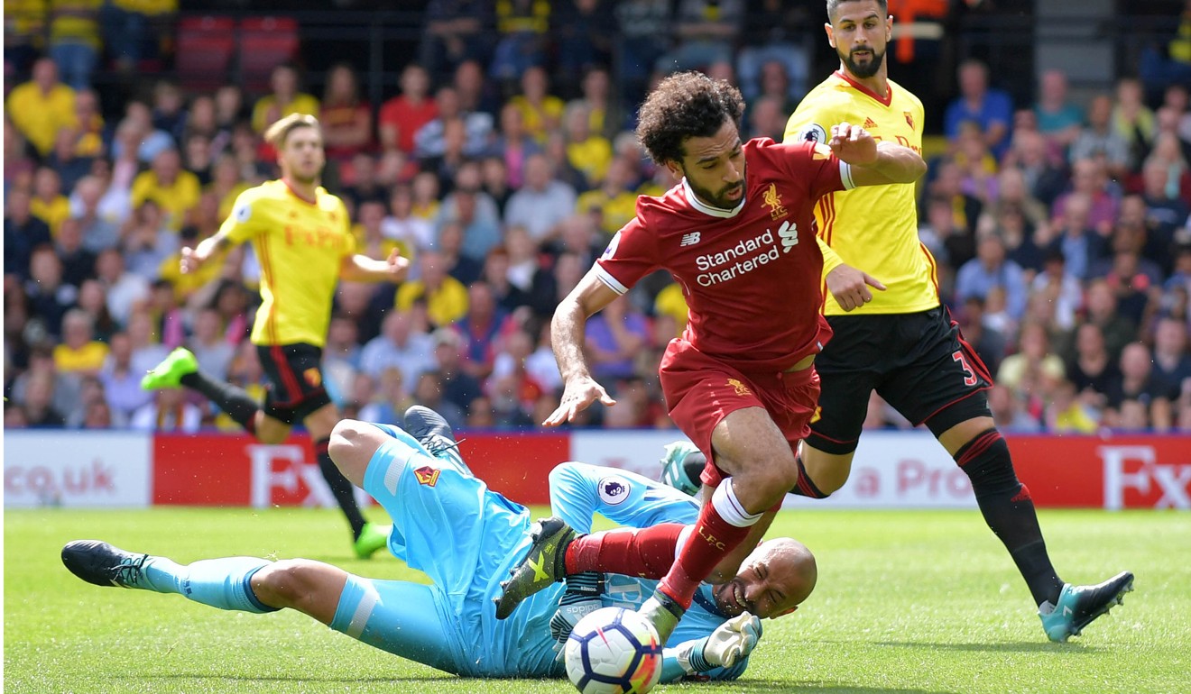 Watford's Brazilian goalkeeper Heurelho Gomes fouls Liverpool's Egyptian midfielder Mohamed Salah to concede a penalty. Photo: AFP
