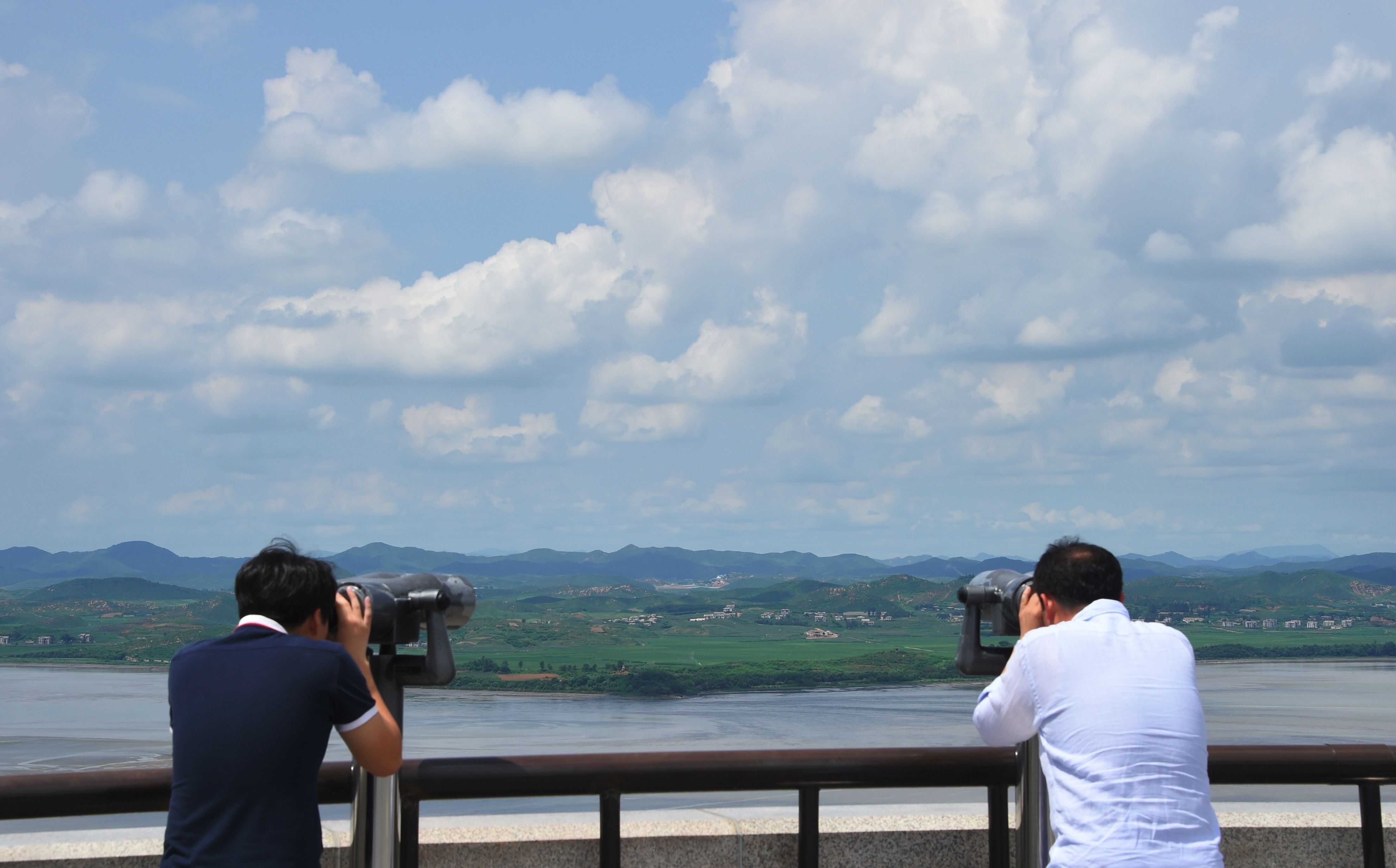 Visitors look through binoculars towards North Korea from a South Korean observation post in Paju, near the demilitarised zone dividing the two Koreas, on August 11. Photo: AFP