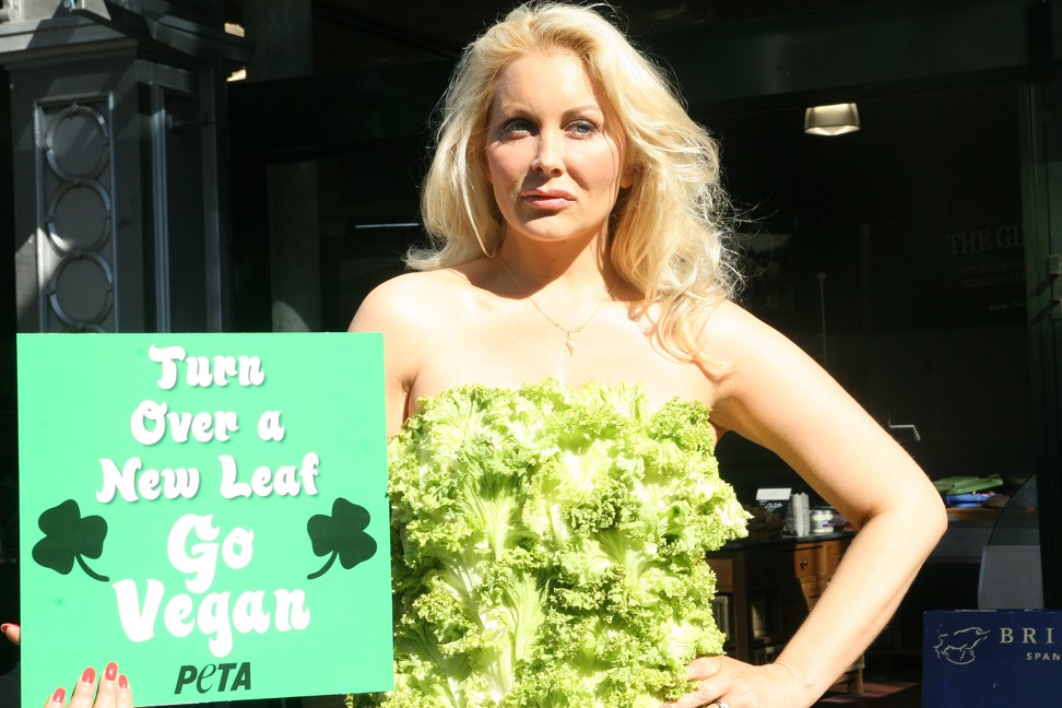 A “lettuce lady” promotes veganism outside Borough Street market in London wearing Peta’s lettuce gown. Photo: Alamy