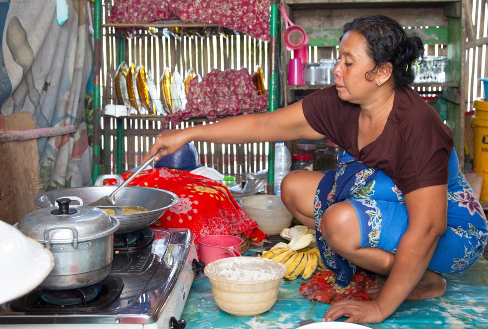 A woman fries bananas in a floating village on Tempe Lake, in Sulawesi, Indonesia. Picture: Alamy