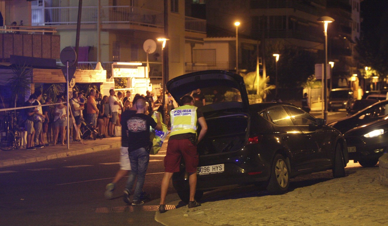 Spanish police inspect a car after five suspected terrorists were shot dead in the coastal resort of Cambrils. Photo: EPA