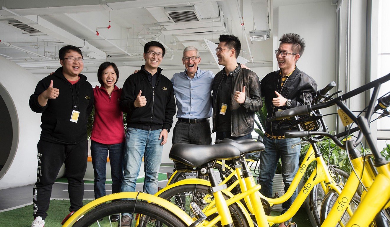 Apple Chief Executive Officer Tim Cook (centre) visiting the Beijing-based bike-sharing start-up Ofo in Beijing. Photo: Handout