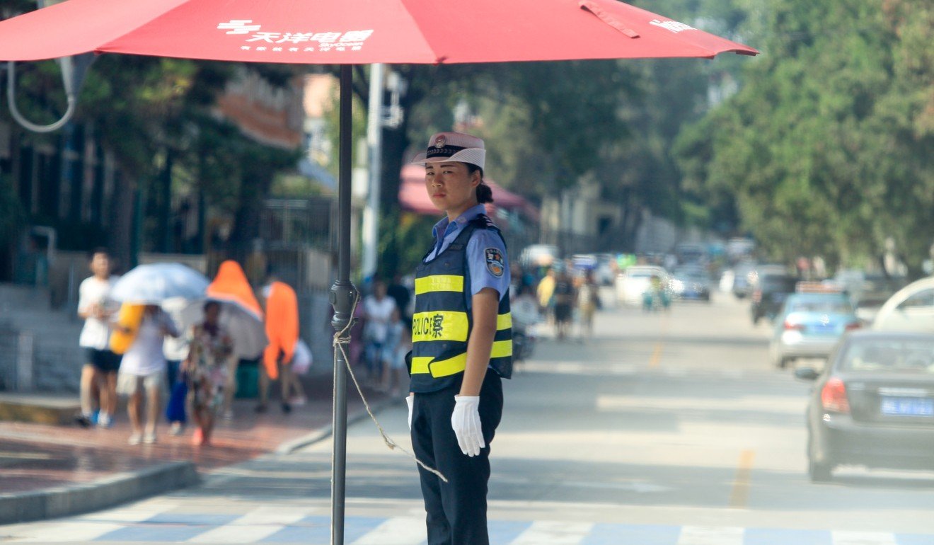 A police woman controlling traffic in Beidaihe. Photo: Simon Song
