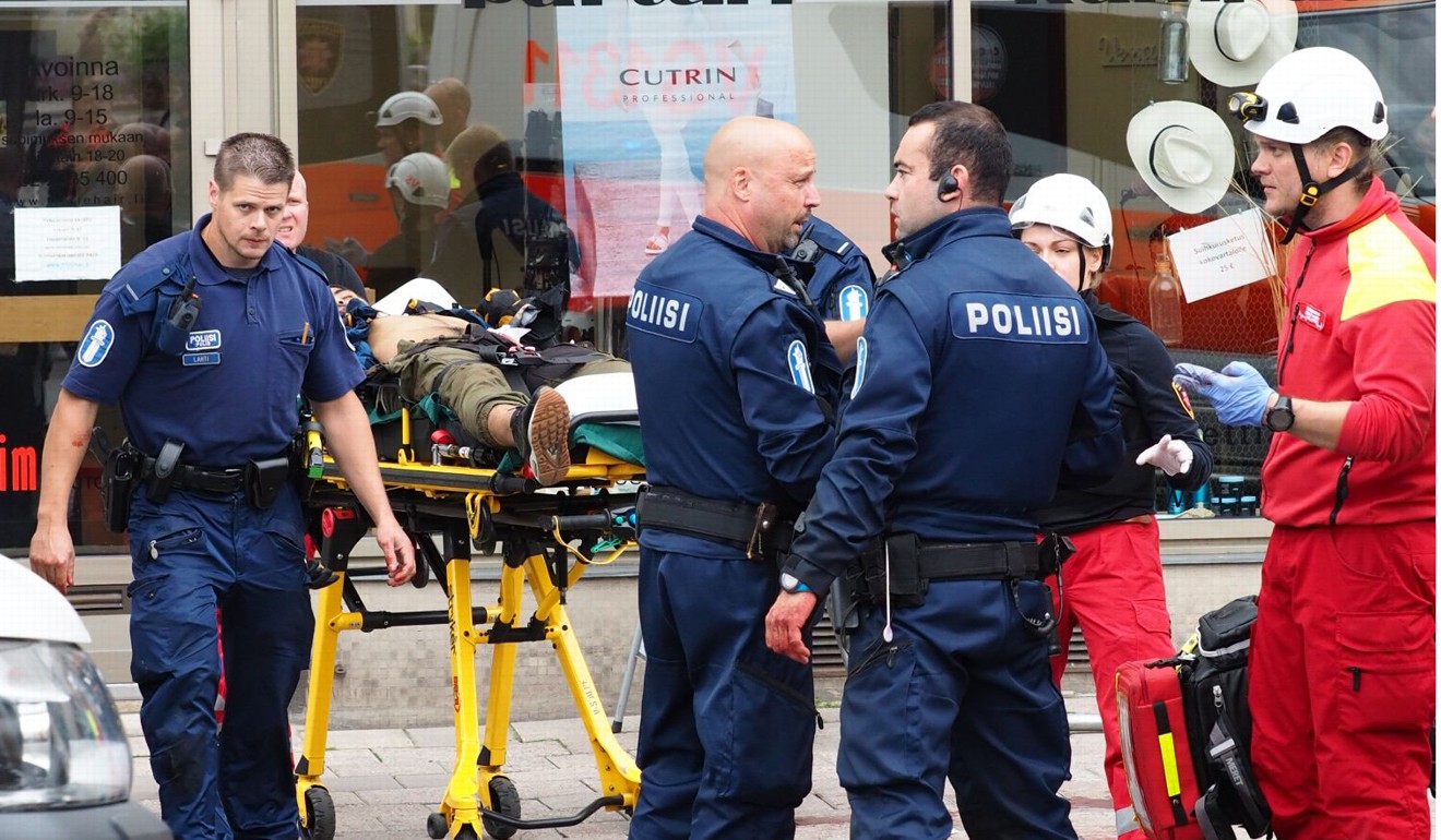 Police officers and rescuers stand next to a person lying on a stretcher in the Finnish city of Turku where several people were stabbed on August 18, 2017. Photo: AFP