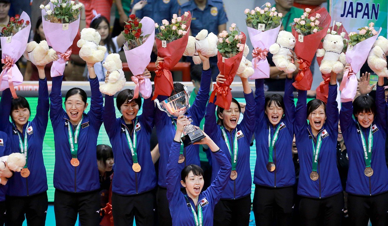 Japan players celebrate on the podium after winning the Asian senior championship for the fourth time.