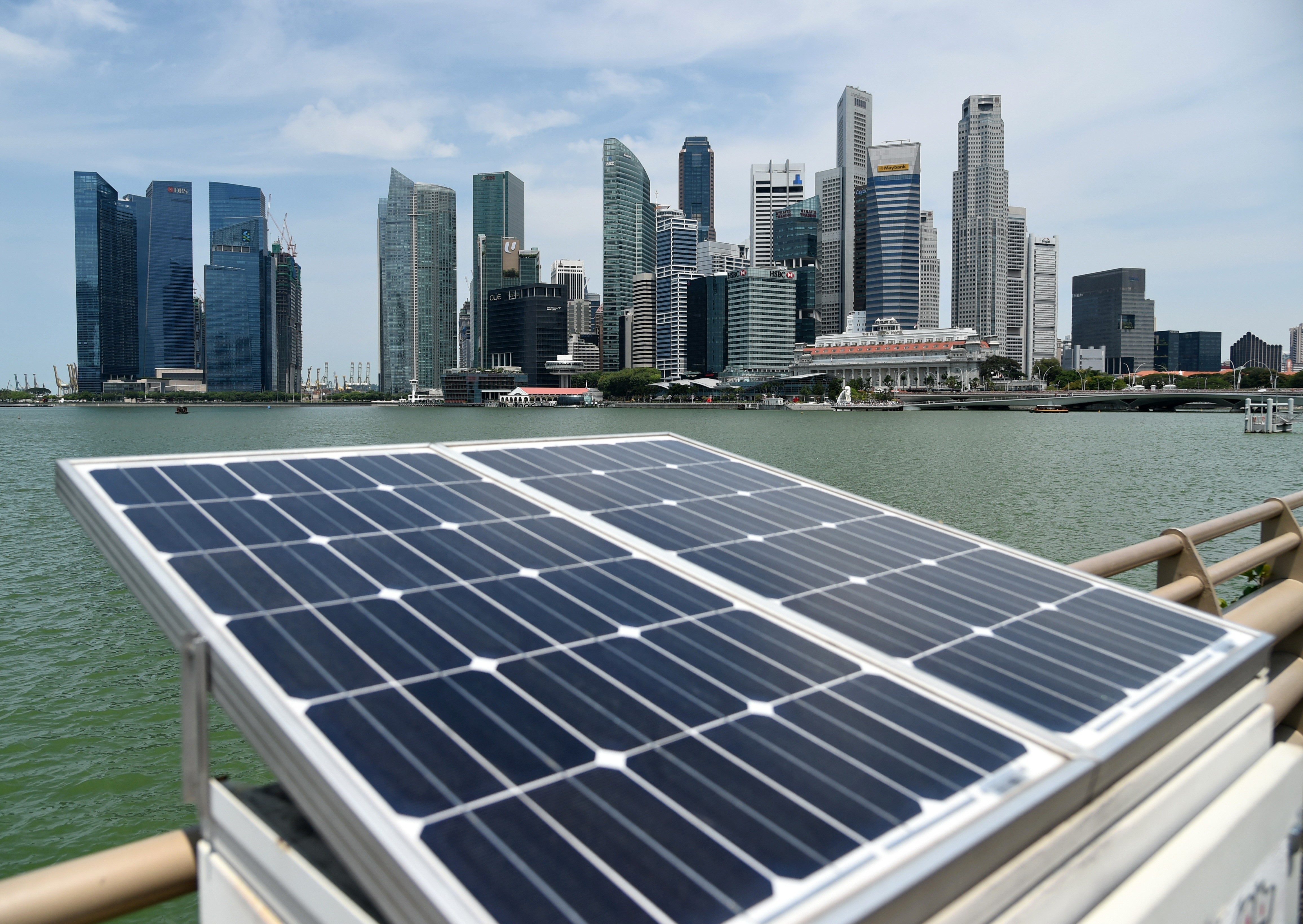 Solar panels used to power walkway lights are positioned along the Marina Bay overlooking the skyscrapers of Singapore in April last year. Singapore’s efficiency ratio on innovation is below the global average, and it is not a good example for Hong Kong to mirror. Photo: AFP