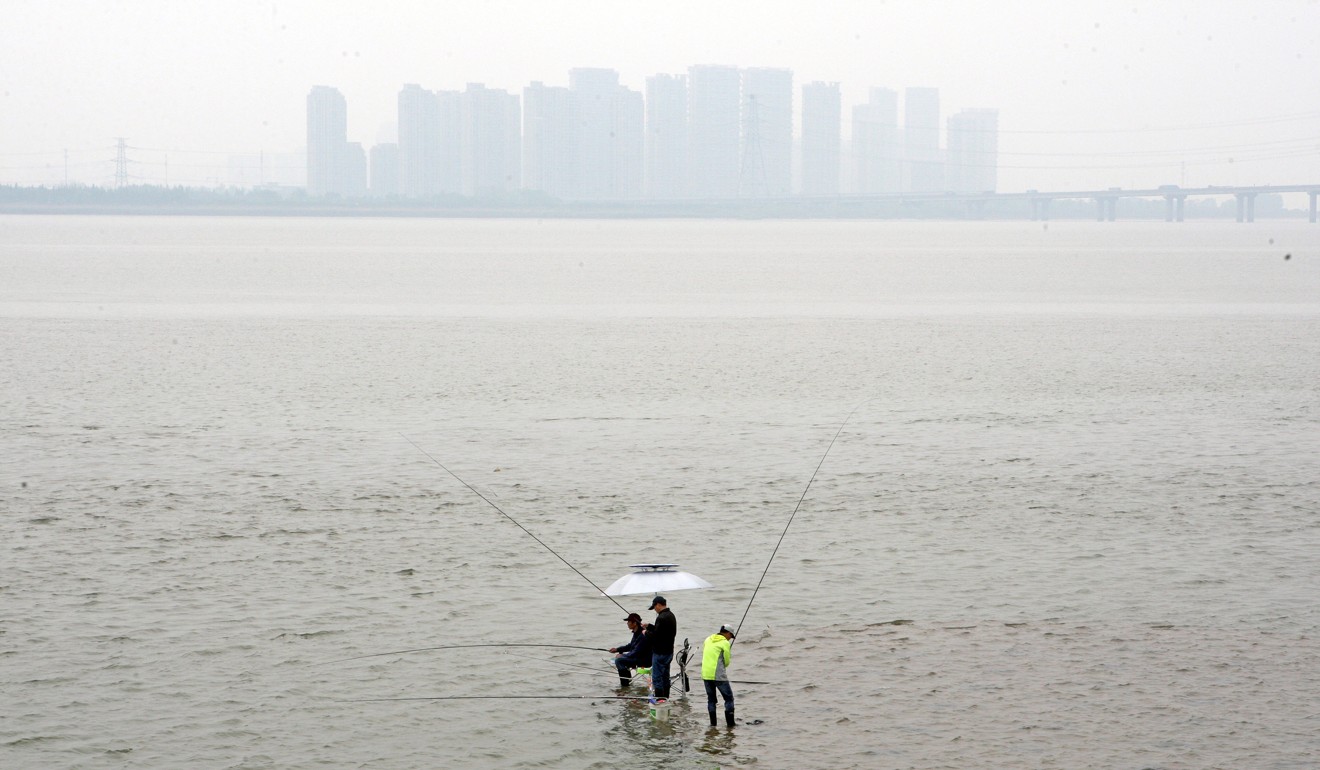 People fish on the Qiantang River in Hangzhou, Zhejiang province, China. Xi is introducing a new system to improve the management of China’s rivers. Photo: Reuters