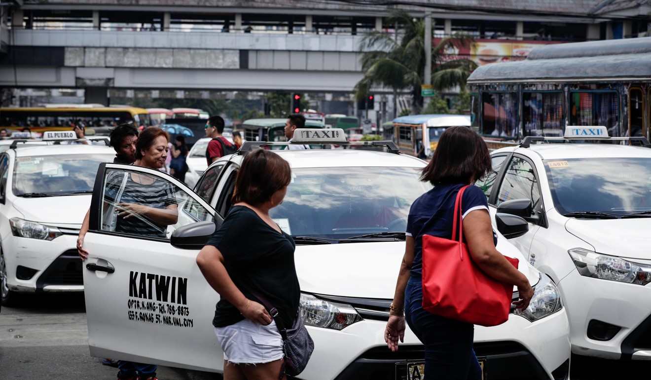 Women prepare to board taxis in Manila, Philippines. Photo: EPA