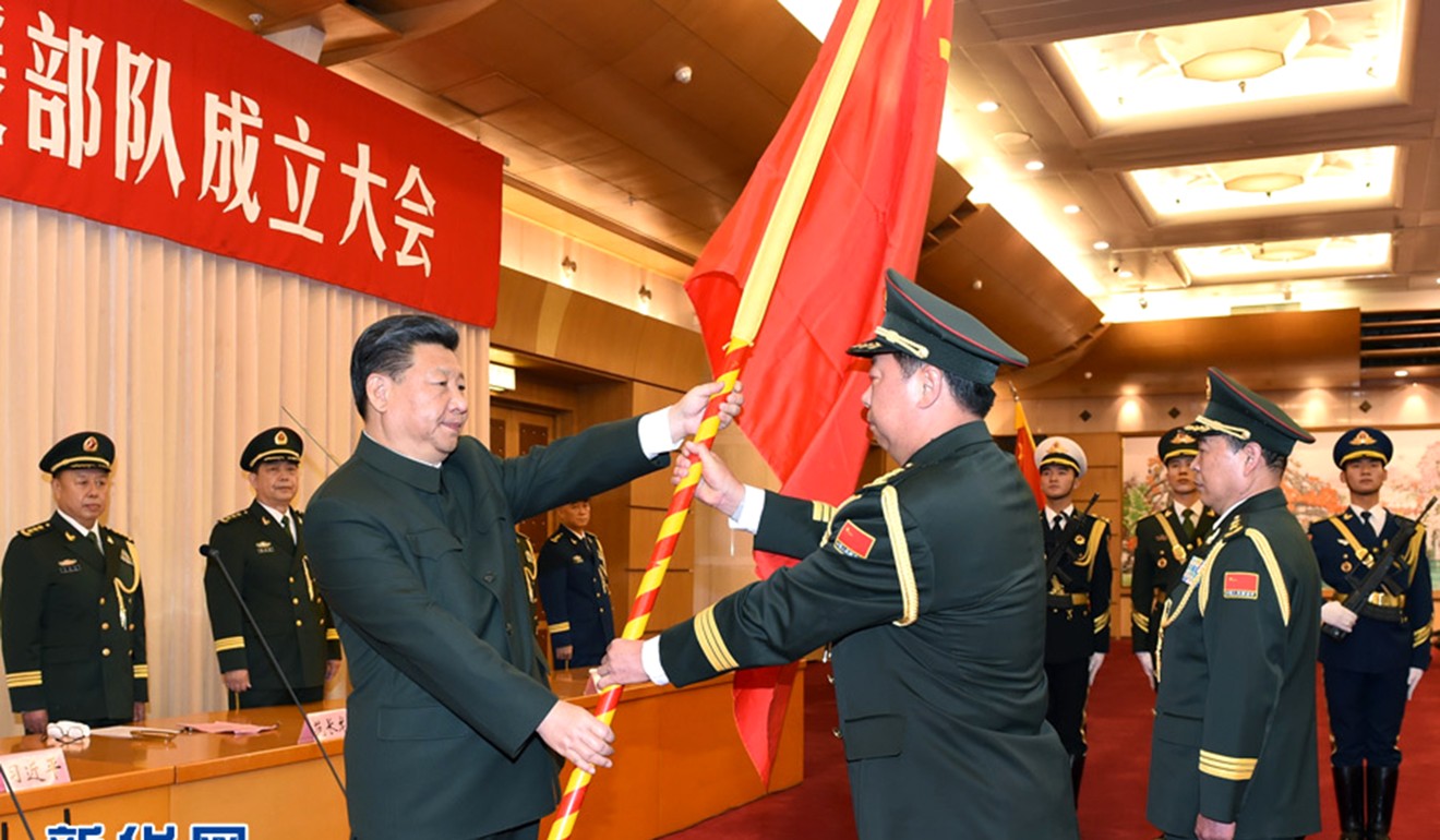 President Xi Jinping hands a military flag to General Li Zuocheng, commander of the new-established PLA's Army general command last year. Photo: Xinhua