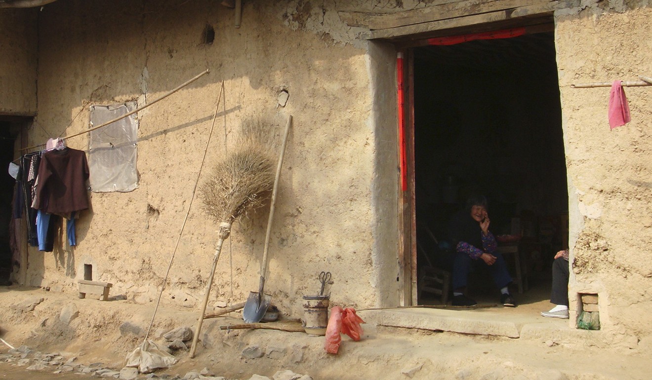 A resident sits in her house in Shajiawan, a rural part of Anhui province. Photo: Reuters