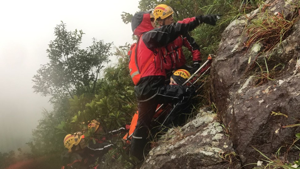 Firemen rescue stranded hikers during the rough weather. Photo: Handout