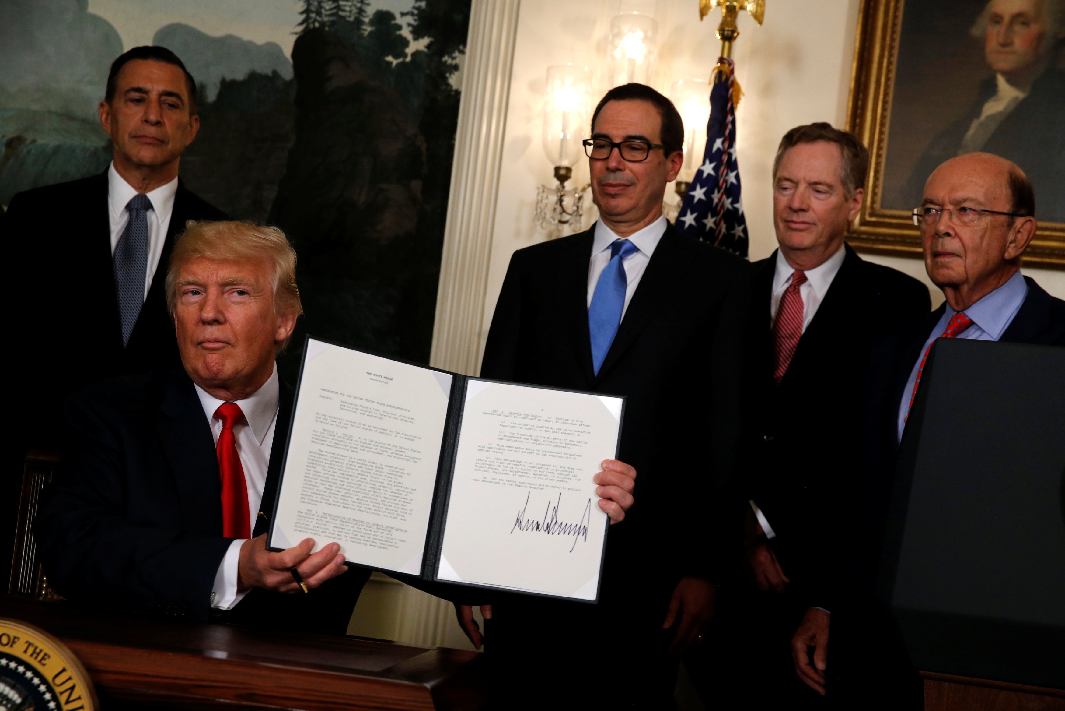 Looking on as US President Donald Trump orders a review of trade issues with China are (from right) Commerce Secretary Wilbur Ross, Trade Representative Robert Lighthizer and Treasury Secretary Steven Mnuchin, at the White House on August 14. Photo: Reuters
