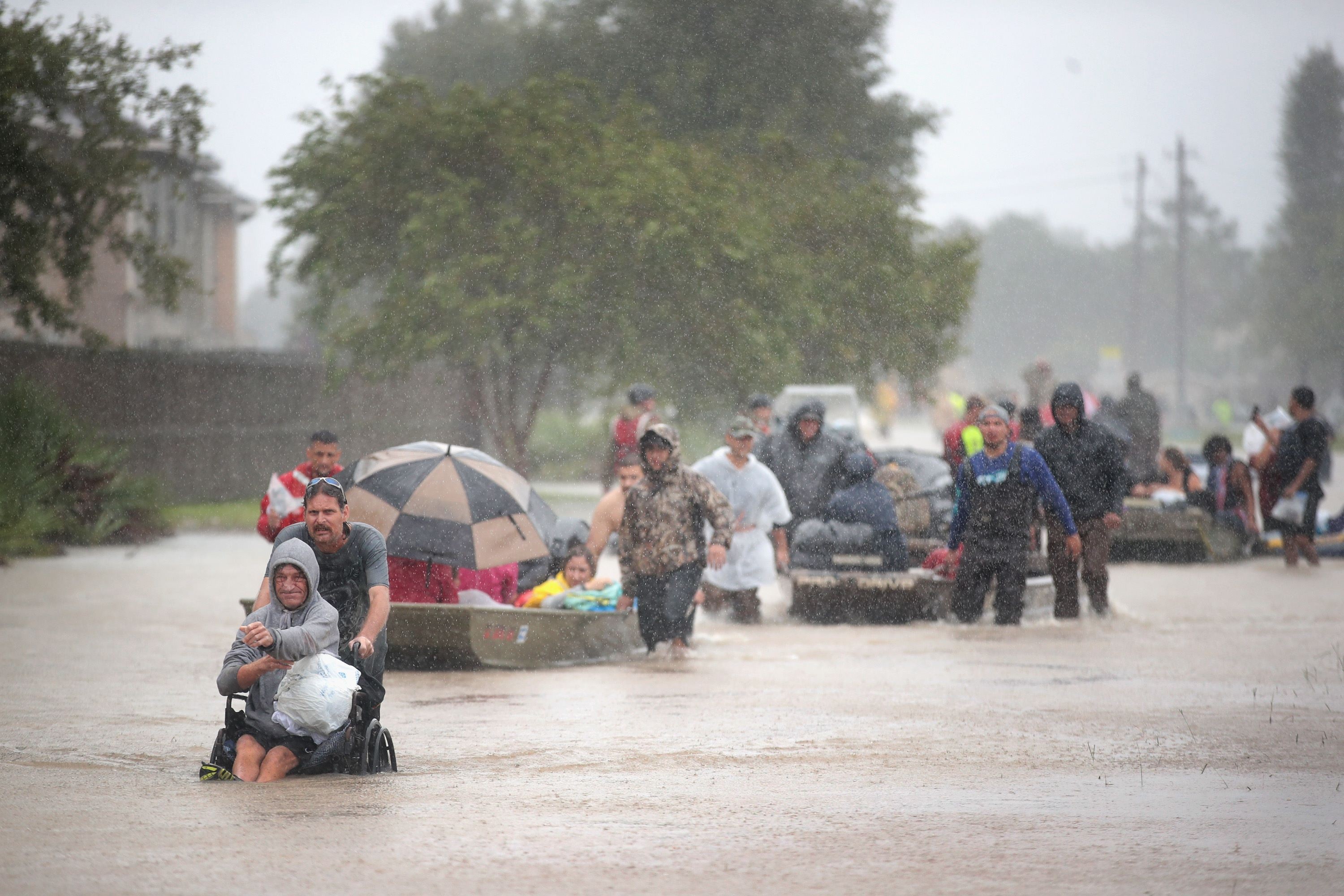 Rain teems down as evacuees are rescued from a flooded neighbourhood in Houston, Texas, on Monday. Photo: AFP
