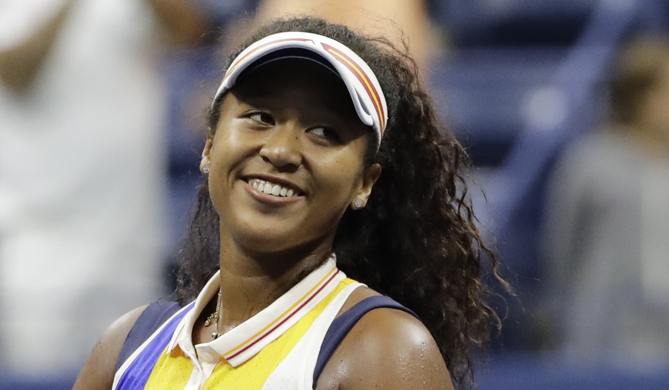 Naomi Osaka, of Japan, smiles after defeating Angelique Kerber, of Germany, in the first round. Photo: AP