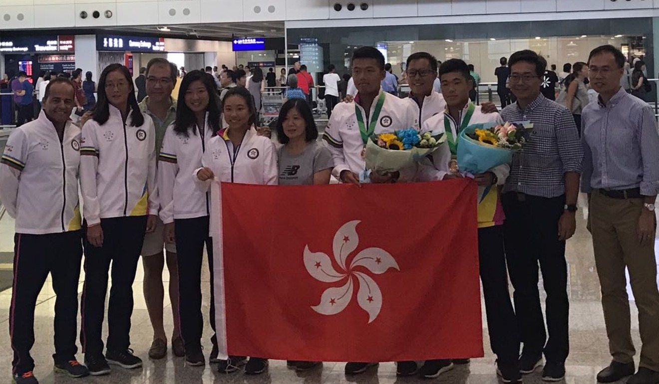 Hong Kong tennis team celebrate with their bronze medal in men's doubles.