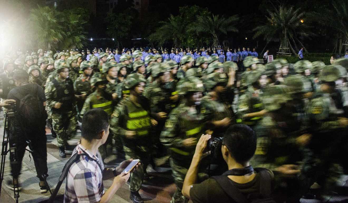 Armed police officers march together before staging multiple raids in Beihai in the early hours of Wednesday morning. The city’s party secretary promised to stamp out pyramid schemes. Photo: CNS