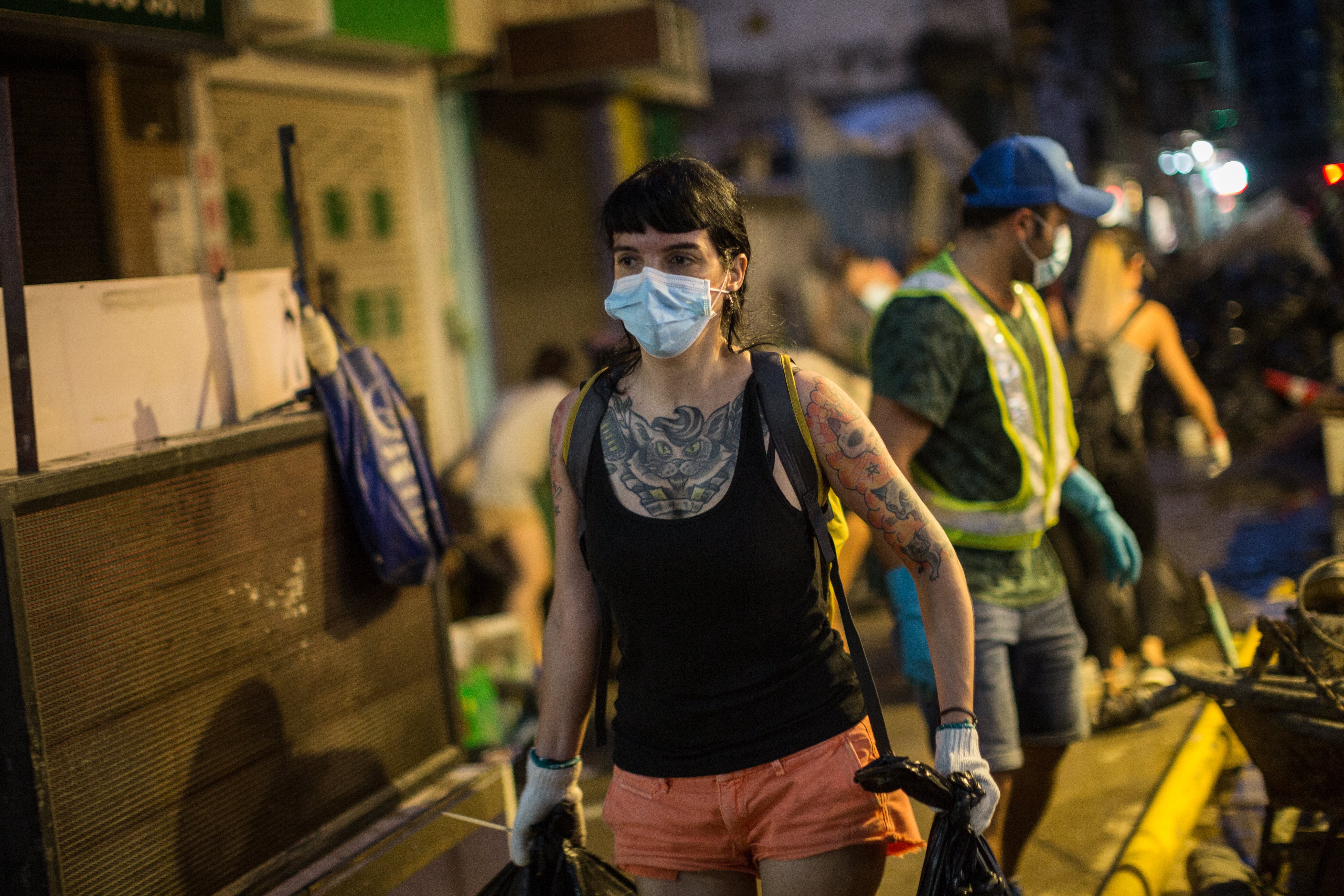 Macau residents volunteer to clean up debris on the streets on August 25, in the wake of Typhoon Hato. Natural disasters that have made the headlines recently magnify the consequences of the political and social choices we’ve made. Photo: EPA