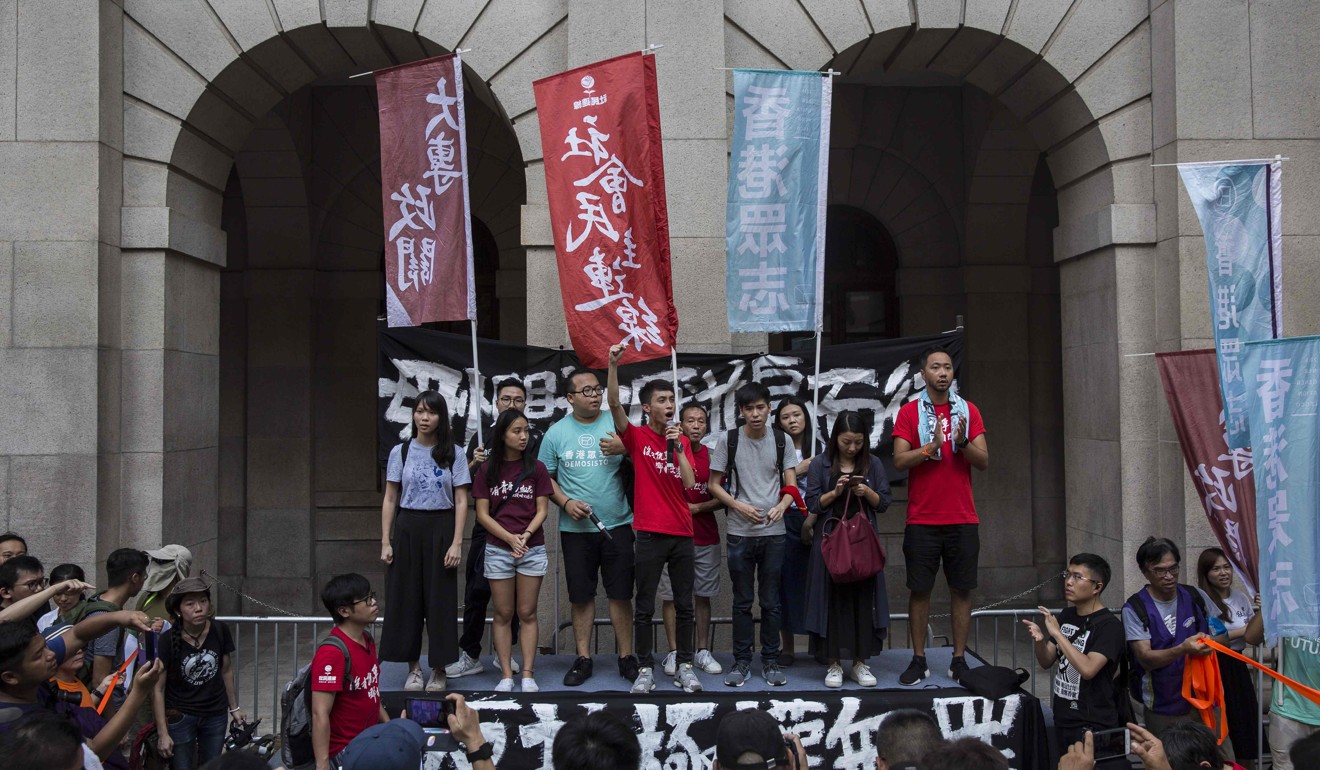 Pro-democracy activists address the crowd outside the Court of Final Appeal on August 20. Smearing our judicial system won’t do Hong Kong any good. The failure of “one country, two systems” won’t bring about a new and better political order; instead, it may well hasten the arrival of “one country, one system” under China. Photo: AFP