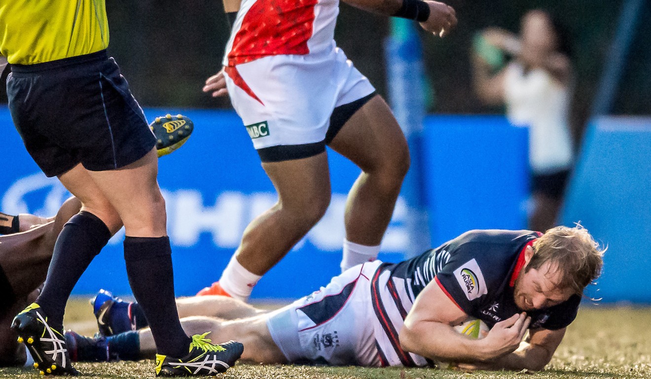 Toby Fenn scores one of his two tries in Hong Kong’s loss to Japan in the final.