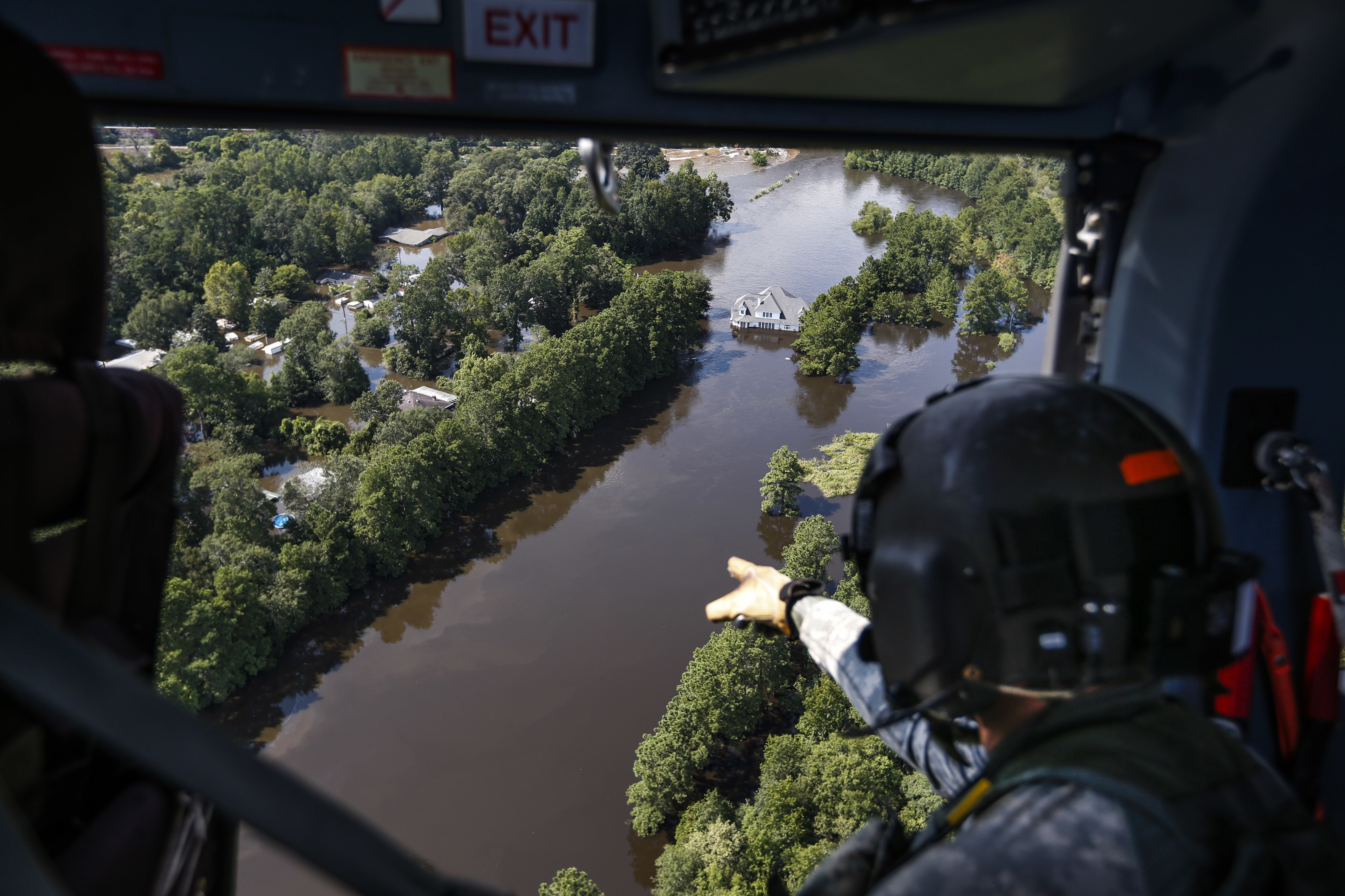 Rescuers scans flooded areas from the air. Photo: AP