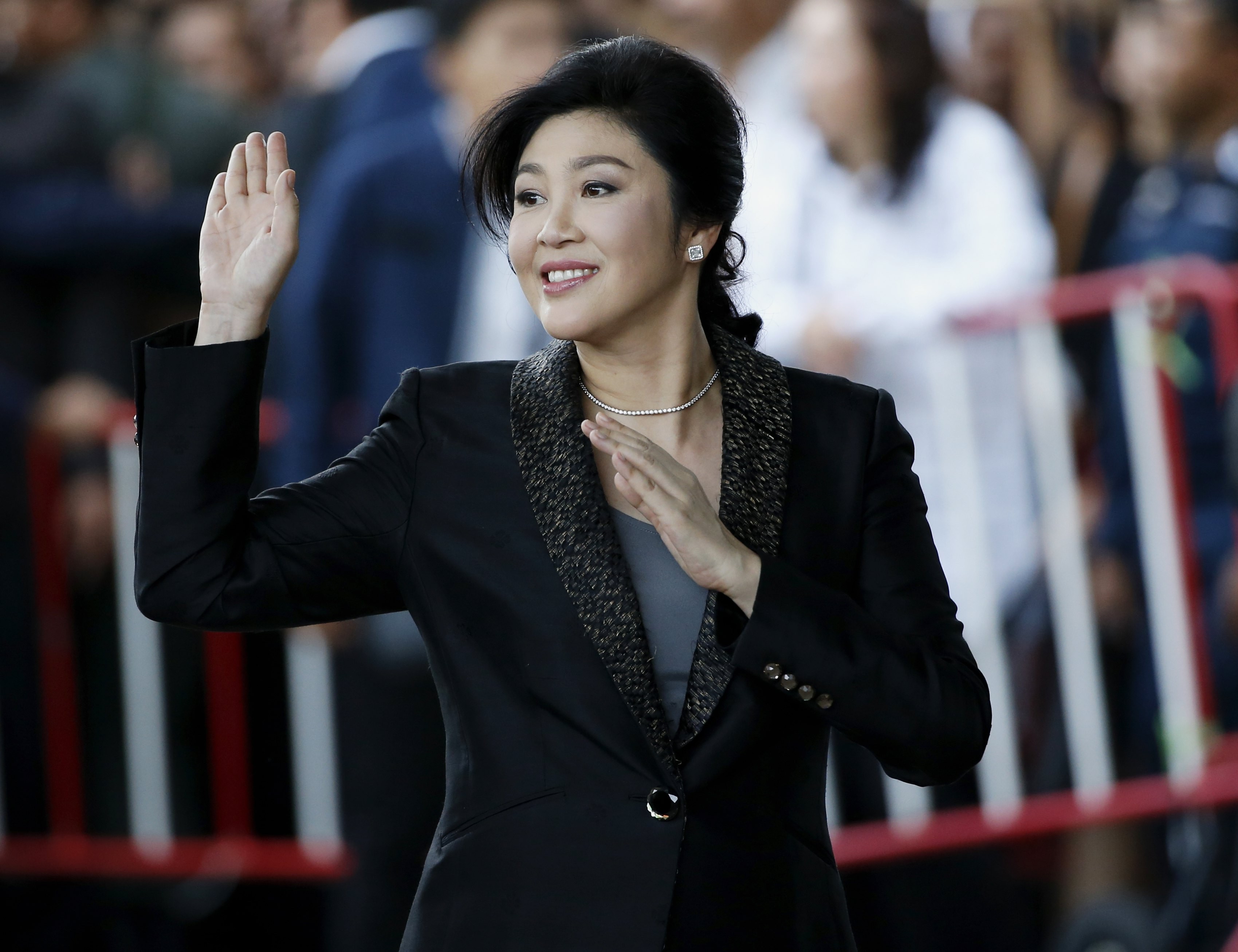 Yingluck Shinawatra waves to supporters as she arrives to deliver closing statements in her trial at the Supreme Court in Bangkok. Photo: EPA