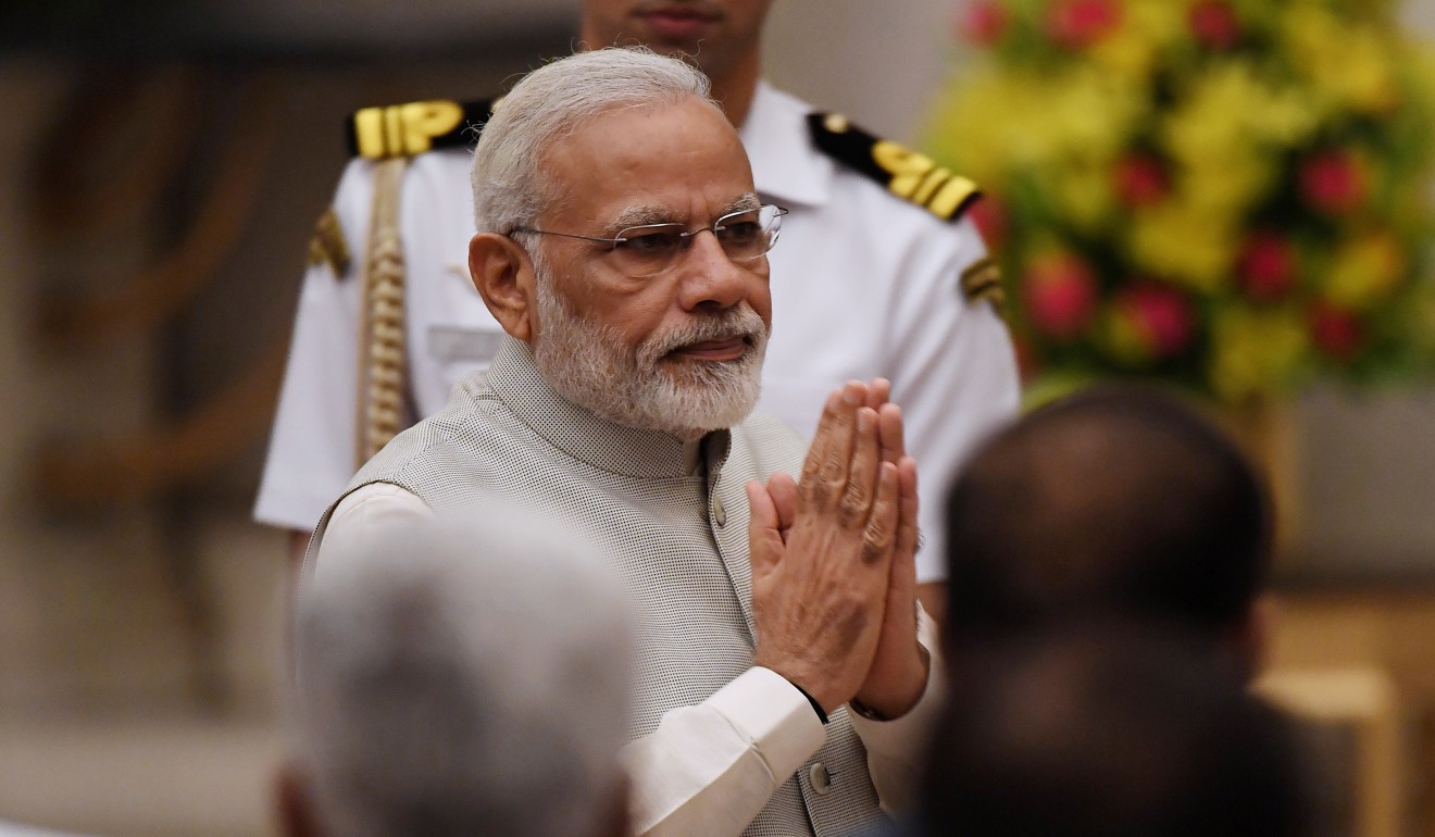 Indian Prime Minister Narendra Modi greets attendees during the swearing-in ceremony of new ministers. Photo: AP