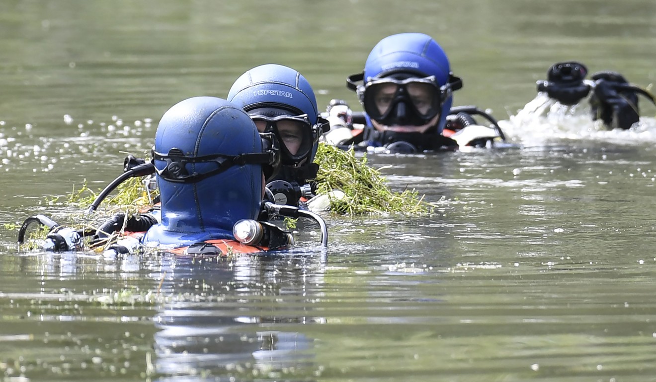Divers of the French gendarmerie search for evidence in a pond near Pont-de-Beauvoisin on August 30 after the disappearance of Maelys de Araujo, aged nine. Photo: AFP