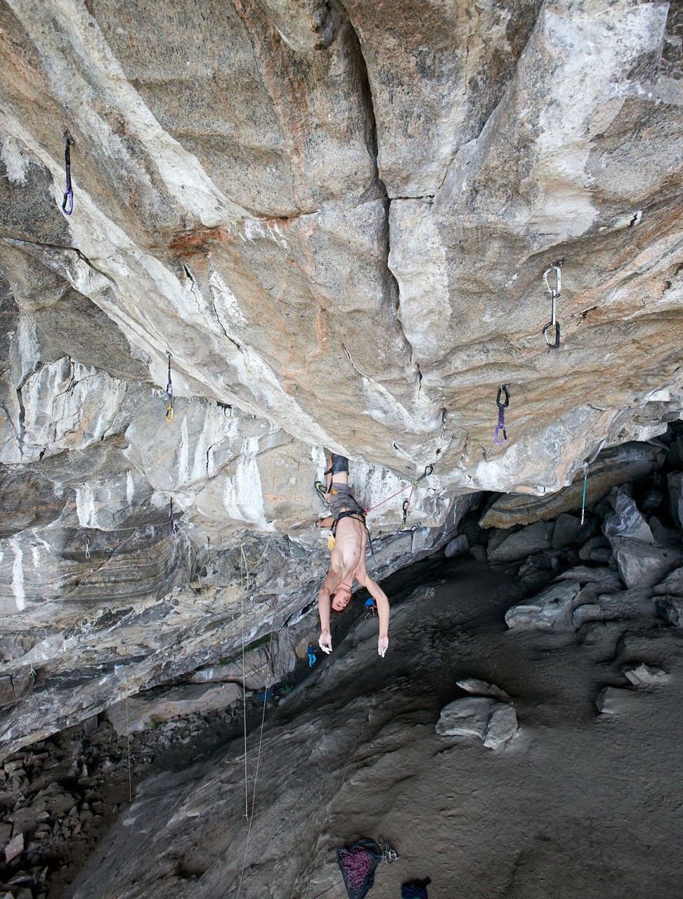 Czech climber Adam Ondra inverted inside the Hanshelleren Cave, Flatanger, Norway, in a preparatory climb ahead of Tuesday's successful attempt on the world's first 9c-rated route in the cave. Photo: Montura