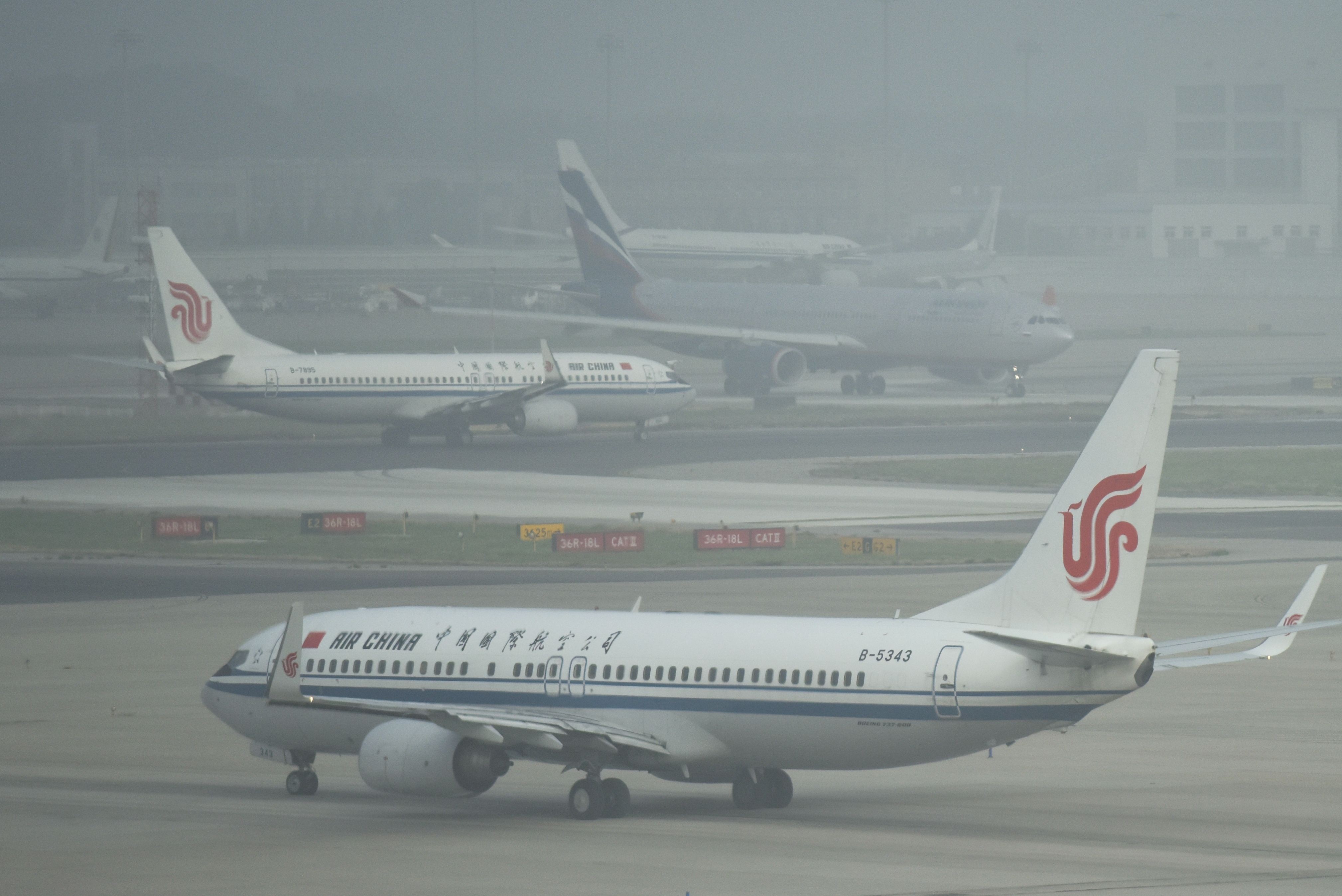 Planes wait to take off on a polluted day at Beijing airport last Friday. Photo: AFP