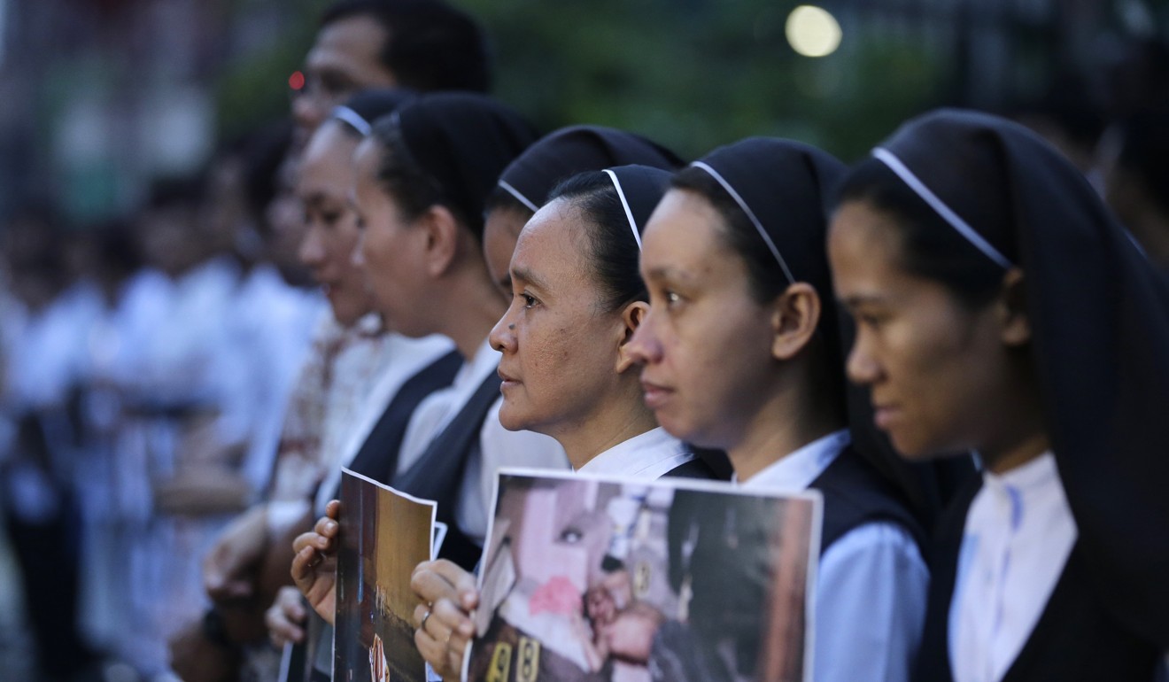 Filipino Catholic nuns link arms during a rally in Manila, on August 29, against drug-related killings and martial law. Photo: AP