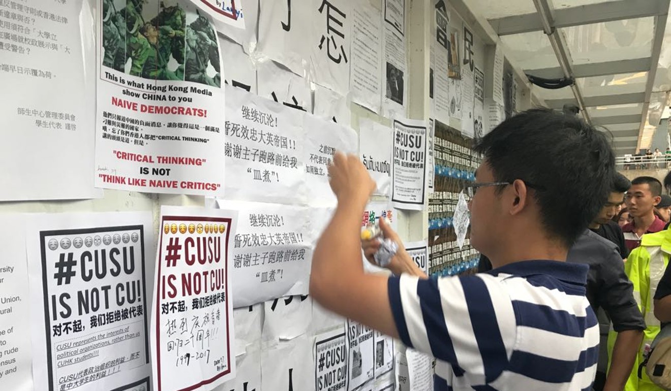 Students from Chinese University post notices on the campus “wall of democracy”. Photo: Elizabeth Cheung