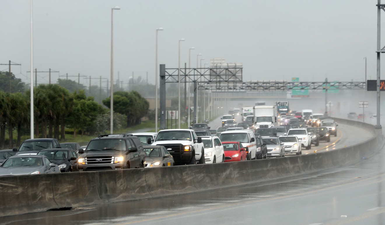 Northbound traffic flees Florida through teeming rain on Thursday near Sunrise. Photo: TNS