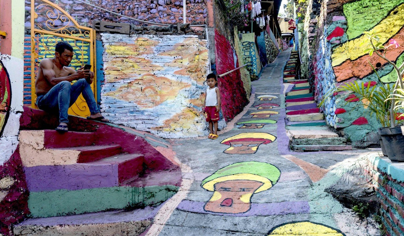 A local relaxes at an Indonesian hamlet dubbed ‘the rainbow village’ in Semarang, central Java. Photo: AFP